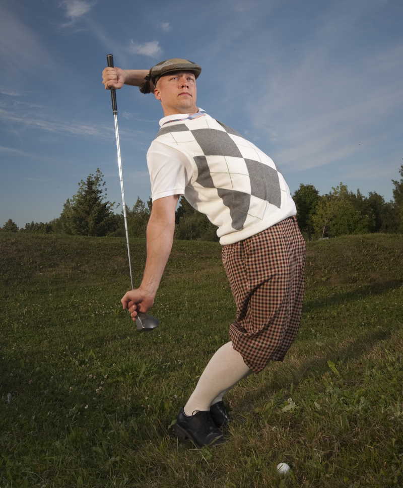 golfer with golf clubs - 
old time golf attire 