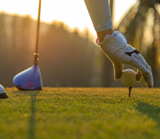 hole-in-one image of golfer teeing up a ball