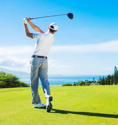 Man hitting a ball with golf clubs