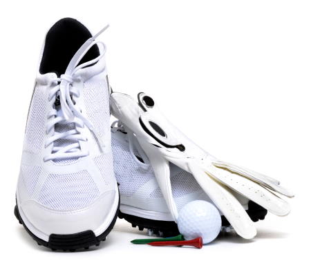 golf shoes with a golf glove, tee, and golf ball