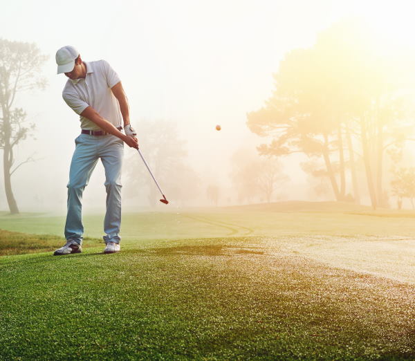 golfer chipping on the green