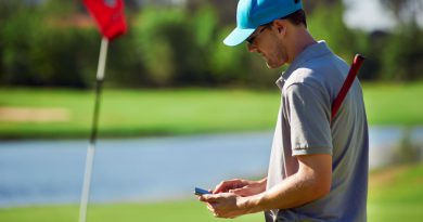 man using golf gps on the golf course - blog feature image