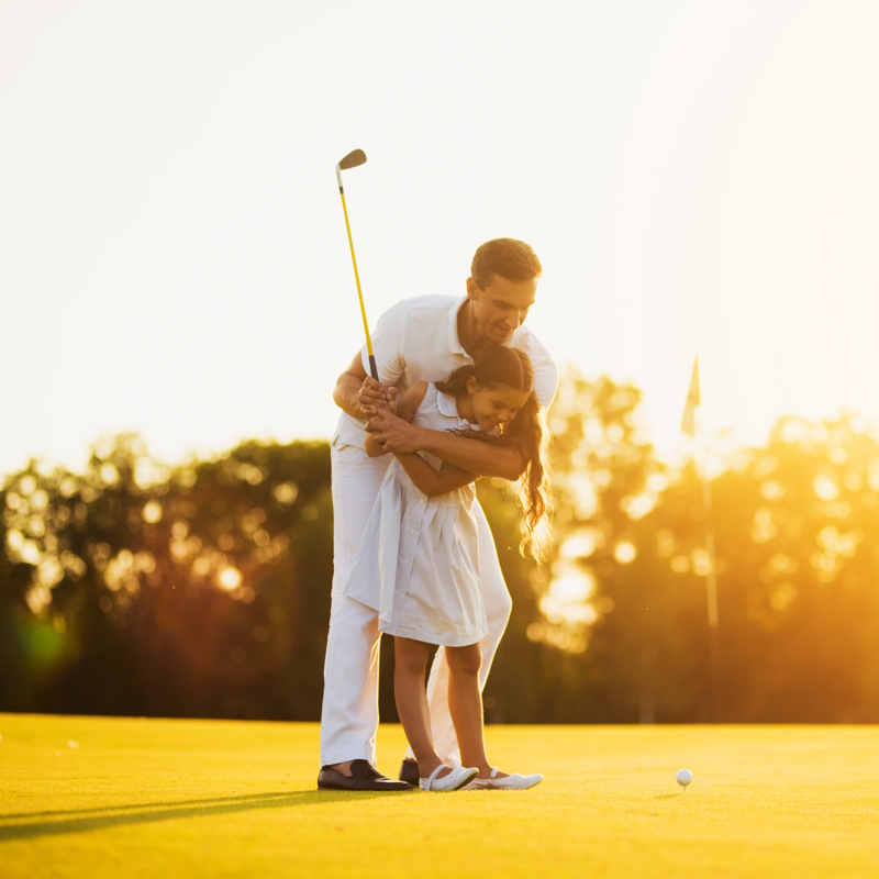 Father's Day Golf gear - daughter playing golf with dad image