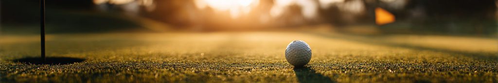 Golf ball near the cup at sunset, illustrating the best golf balls for seniors with soft low-compression feel and easy launch