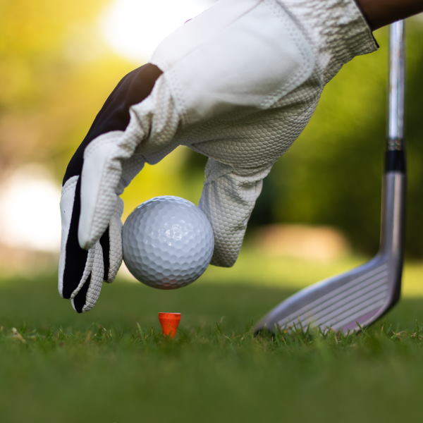 putting a golf ball on a red tee
