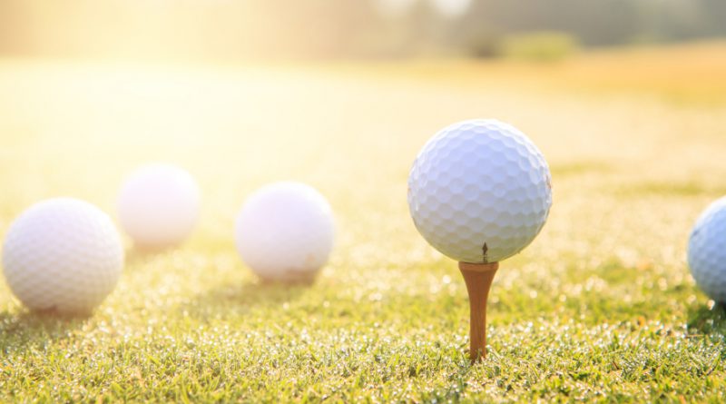 used golf balls on a tee