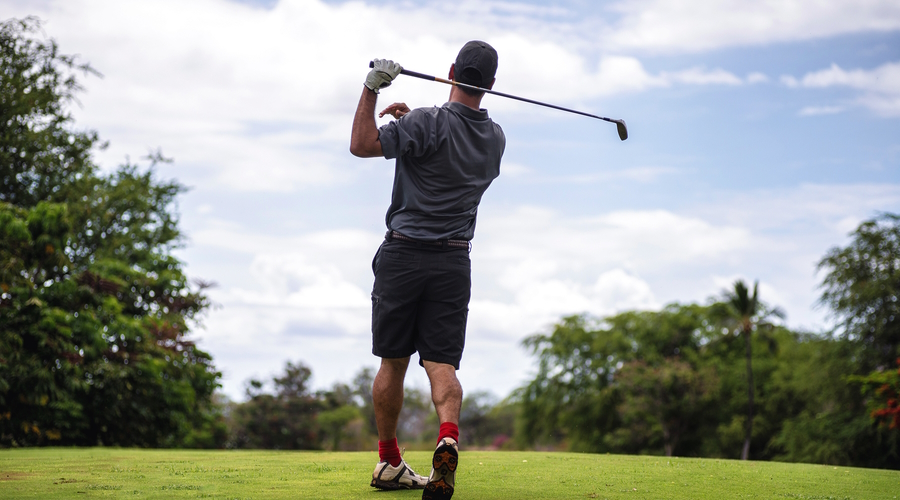 Impact of Altitude on Golf Ball Performance: Tips for High Elevation Play - golfer hitting a shot on the fairway