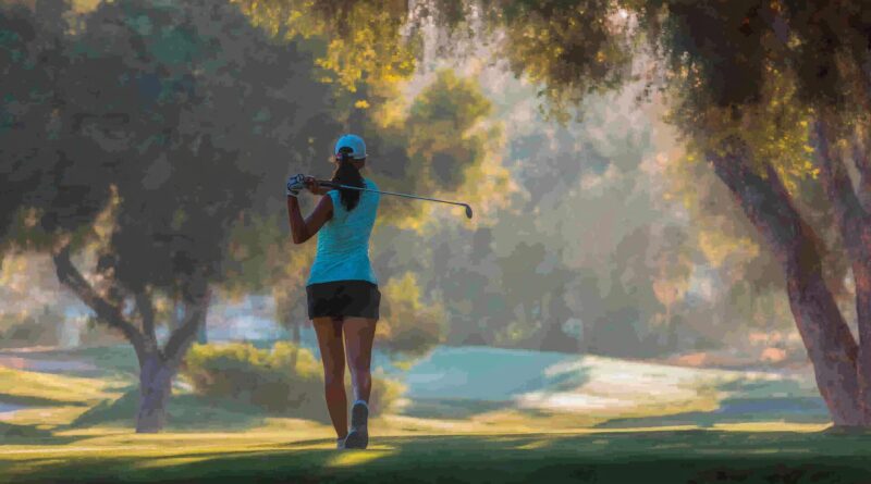 best women's irons for slower swing speeds feature image - back view of a woman golfer, gently hitting an iron on a picturesque golf course